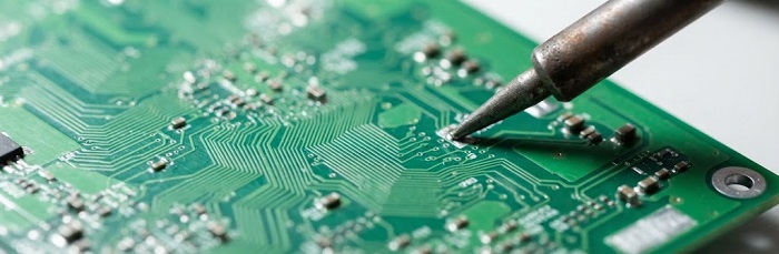 Macro shot of a green printed circuit board under inspection