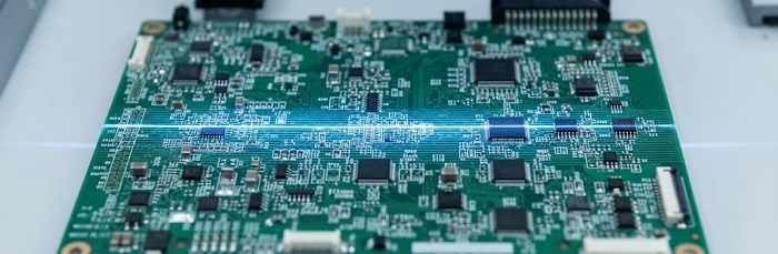 PCB inspection under blue diagnostic light