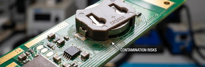 Coin-cell industrial sensor with potential contamination near the battery holder